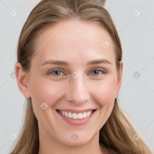 Joyful white young-adult female with long  brown hair and blue eyes