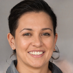 Joyful white adult female with medium  brown hair and brown eyes