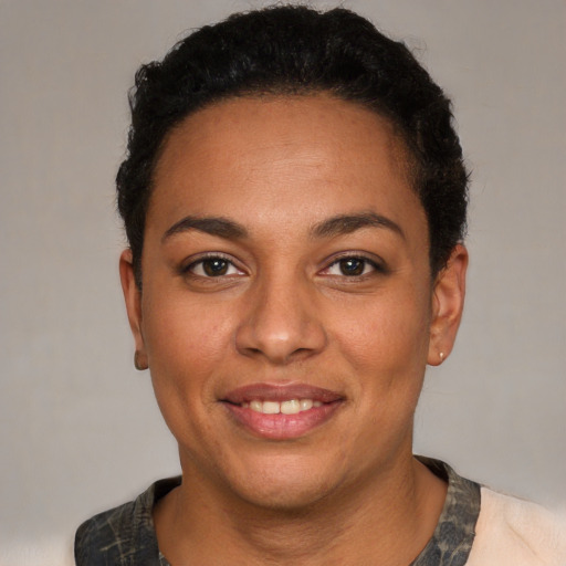 Joyful latino young-adult female with short  black hair and brown eyes