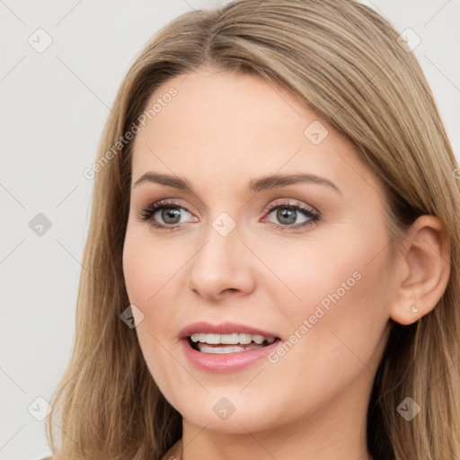 Joyful white young-adult female with long  brown hair and brown eyes