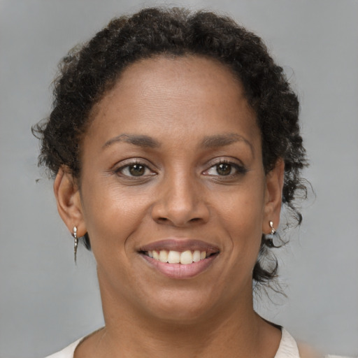 Joyful black young-adult female with short  brown hair and brown eyes