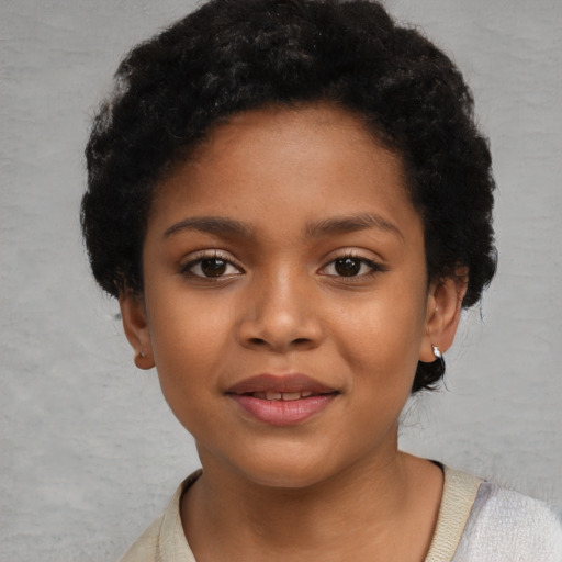 Joyful black child female with short  black hair and brown eyes