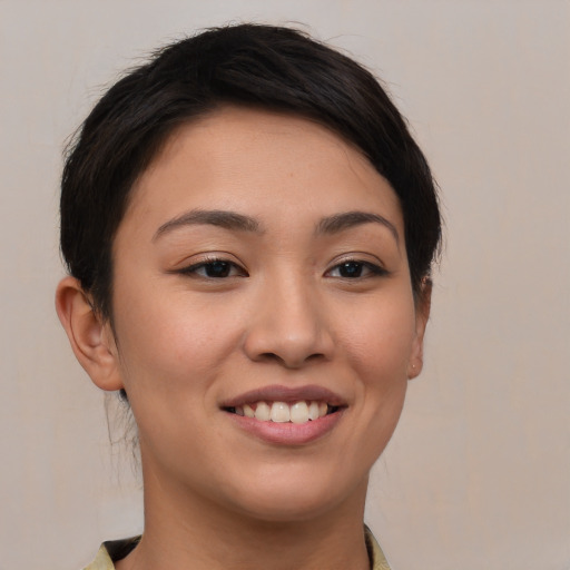 Joyful asian young-adult female with medium  brown hair and brown eyes