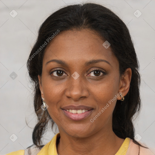 Joyful black adult female with medium  brown hair and brown eyes