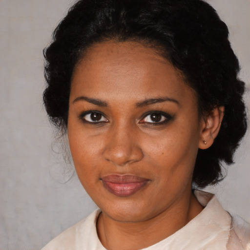 Joyful black young-adult female with medium  black hair and brown eyes