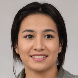 Joyful asian young-adult female with medium  brown hair and brown eyes