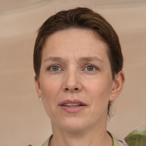 Joyful white adult female with short  brown hair and grey eyes