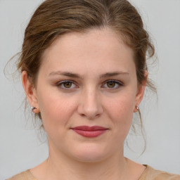 Joyful white young-adult female with medium  brown hair and green eyes