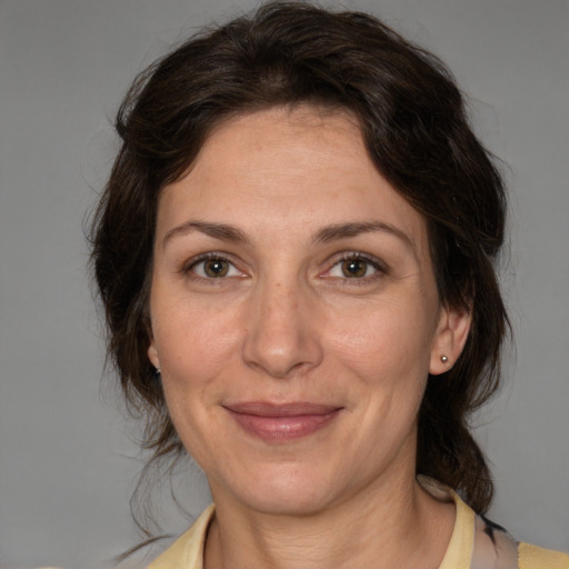 Joyful white adult female with medium  brown hair and brown eyes