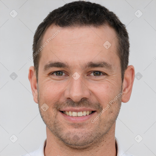 Joyful white adult male with short  brown hair and brown eyes