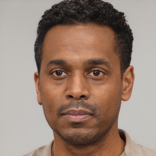 Neutral black young-adult male with short  black hair and brown eyes