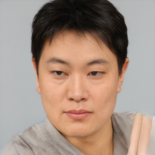 Neutral asian young-adult male with short  brown hair and brown eyes