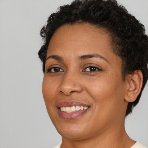 Joyful latino young-adult female with short  black hair and brown eyes