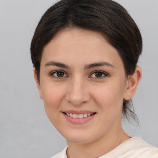 Joyful white young-adult female with short  brown hair and brown eyes