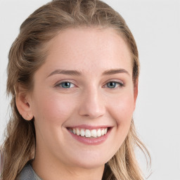 Joyful white young-adult female with long  brown hair and blue eyes