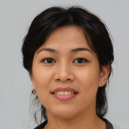 Joyful asian young-adult female with medium  brown hair and brown eyes