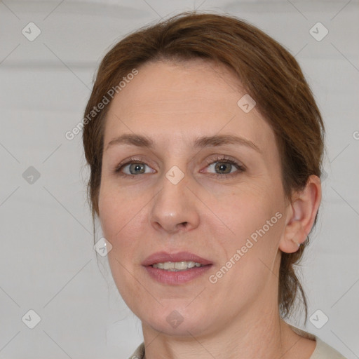 Joyful white adult female with medium  brown hair and grey eyes