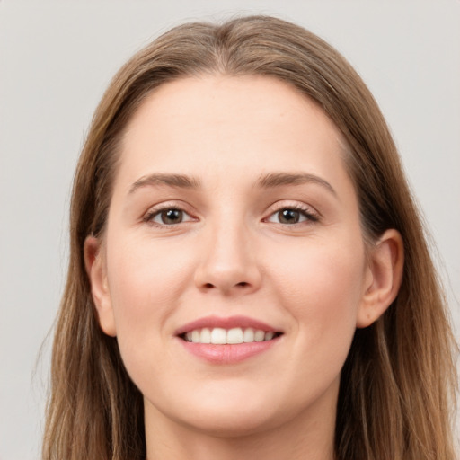 Joyful white young-adult female with long  brown hair and grey eyes