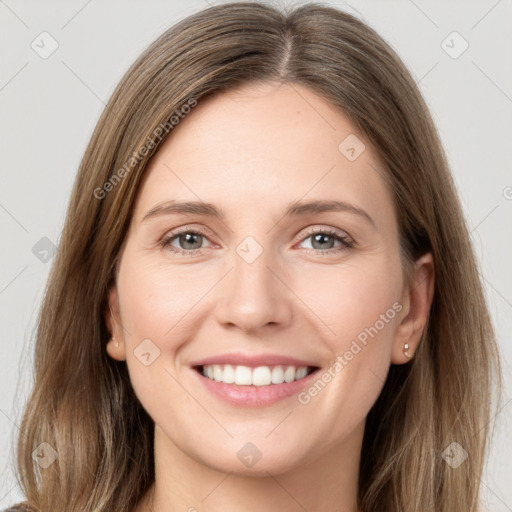 Joyful white young-adult female with long  brown hair and grey eyes