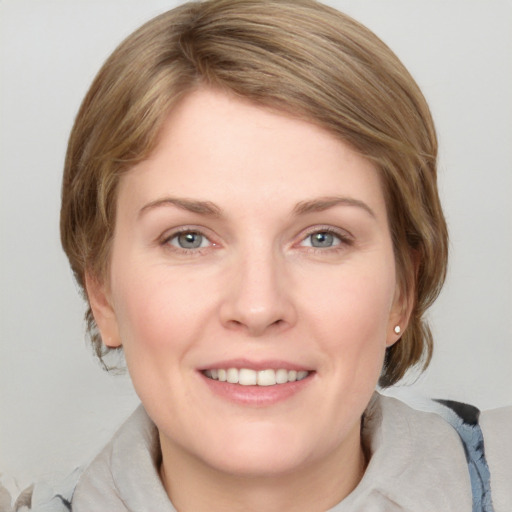 Joyful white young-adult female with medium  brown hair and blue eyes