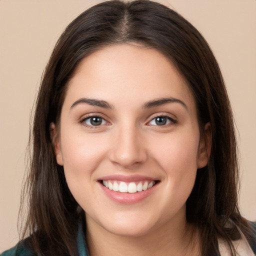 Joyful white young-adult female with long  brown hair and brown eyes