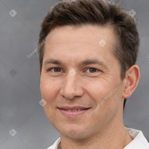 Joyful white adult male with short  brown hair and brown eyes