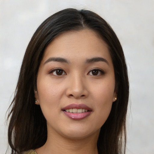 Joyful asian young-adult female with long  brown hair and brown eyes