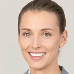 Joyful white young-adult female with short  brown hair and grey eyes