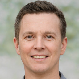 Joyful white adult male with short  brown hair and grey eyes