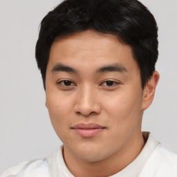Joyful asian young-adult male with short  black hair and brown eyes