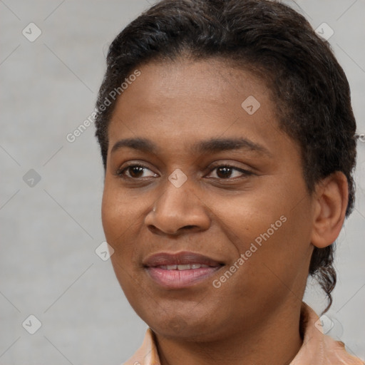 Joyful black young-adult female with short  brown hair and brown eyes