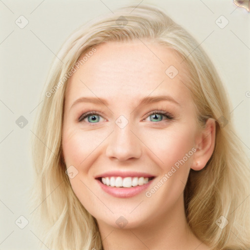 Joyful white young-adult female with long  brown hair and blue eyes