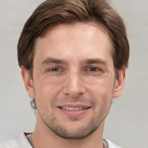 Joyful white adult male with short  brown hair and grey eyes