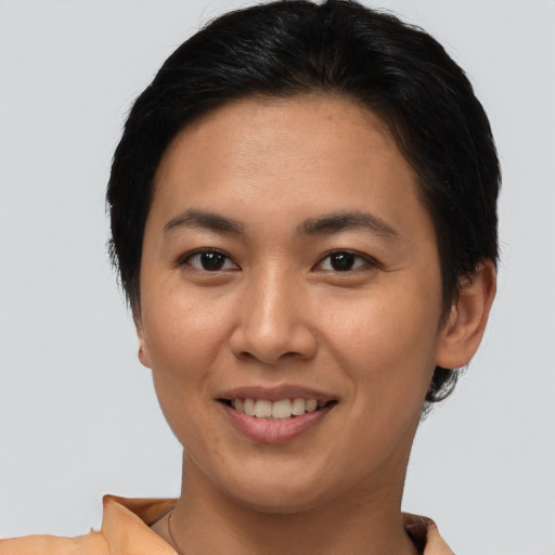 Joyful asian young-adult female with short  brown hair and brown eyes
