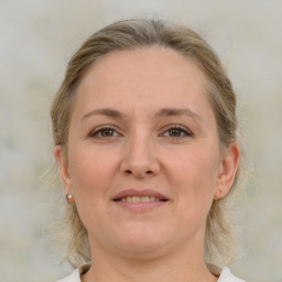 Joyful white adult female with medium  brown hair and grey eyes