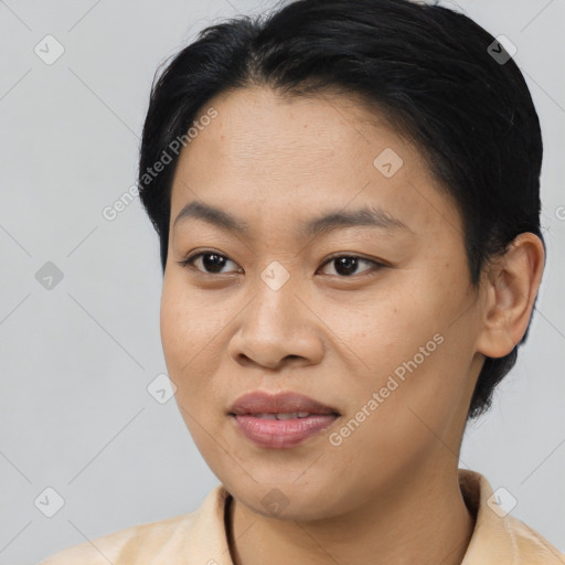 Joyful asian young-adult female with short  black hair and brown eyes