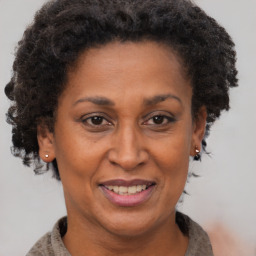 Joyful black adult female with short  brown hair and brown eyes