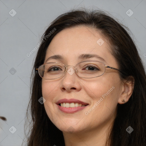 Joyful white adult female with long  brown hair and brown eyes