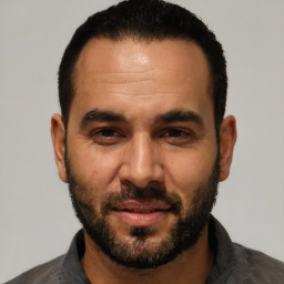 Joyful white adult male with short  black hair and brown eyes