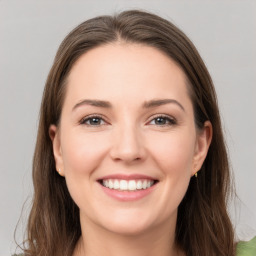 Joyful white young-adult female with long  brown hair and green eyes