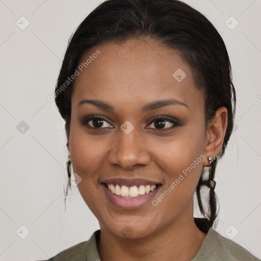 Joyful black young-adult female with medium  black hair and brown eyes