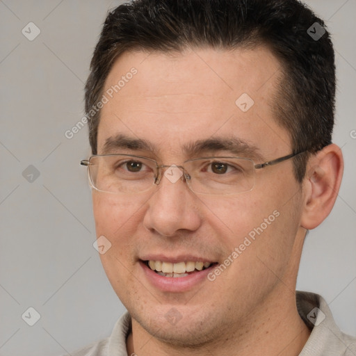 Joyful white adult male with short  brown hair and brown eyes