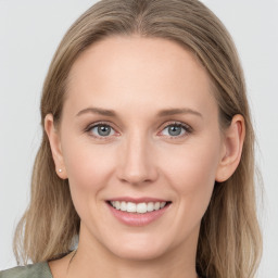 Joyful white young-adult female with long  brown hair and blue eyes