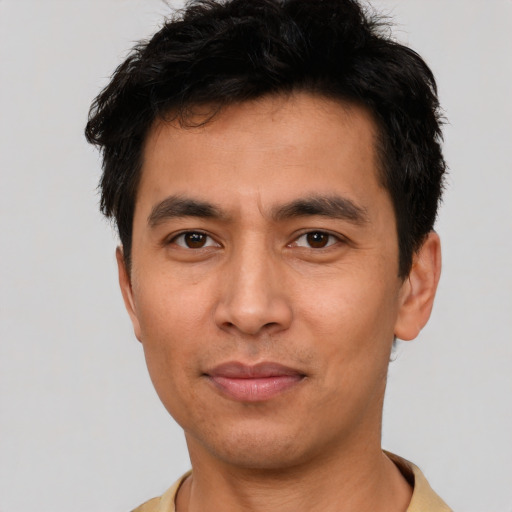 Joyful asian young-adult male with short  brown hair and brown eyes