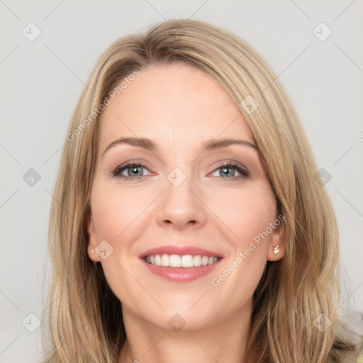 Joyful white young-adult female with long  brown hair and blue eyes