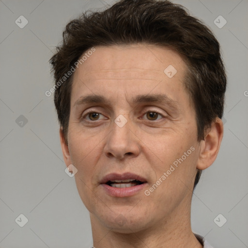 Joyful white adult male with short  brown hair and brown eyes