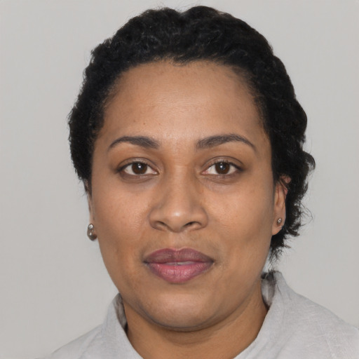 Joyful latino adult female with short  black hair and brown eyes