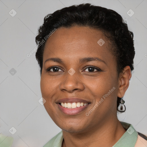 Joyful black young-adult female with short  brown hair and brown eyes