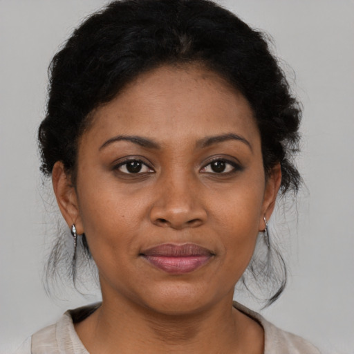 Joyful black young-adult female with short  brown hair and brown eyes