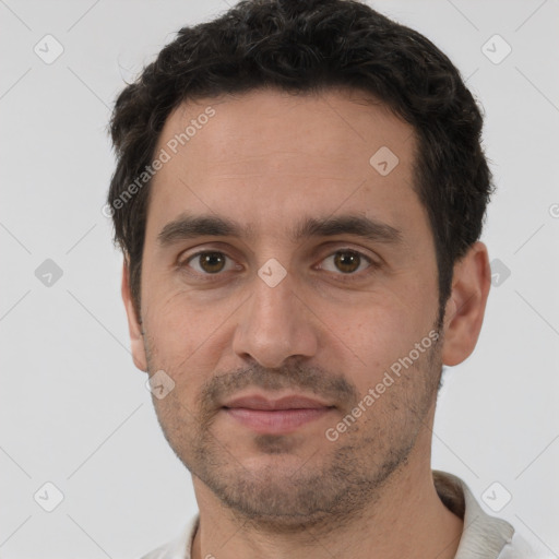 Joyful white young-adult male with short  black hair and brown eyes